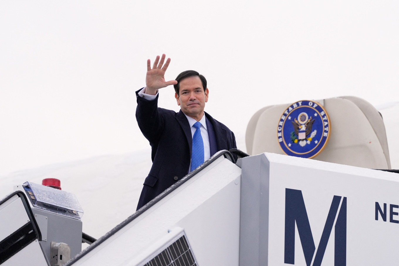 
					U.S. Secretary of State Marco Rubio waves as he departs Munich International Airport on Feb. 15 after attending the Munich Security Conference.					 					Alex Brandon / Pool / AFP				