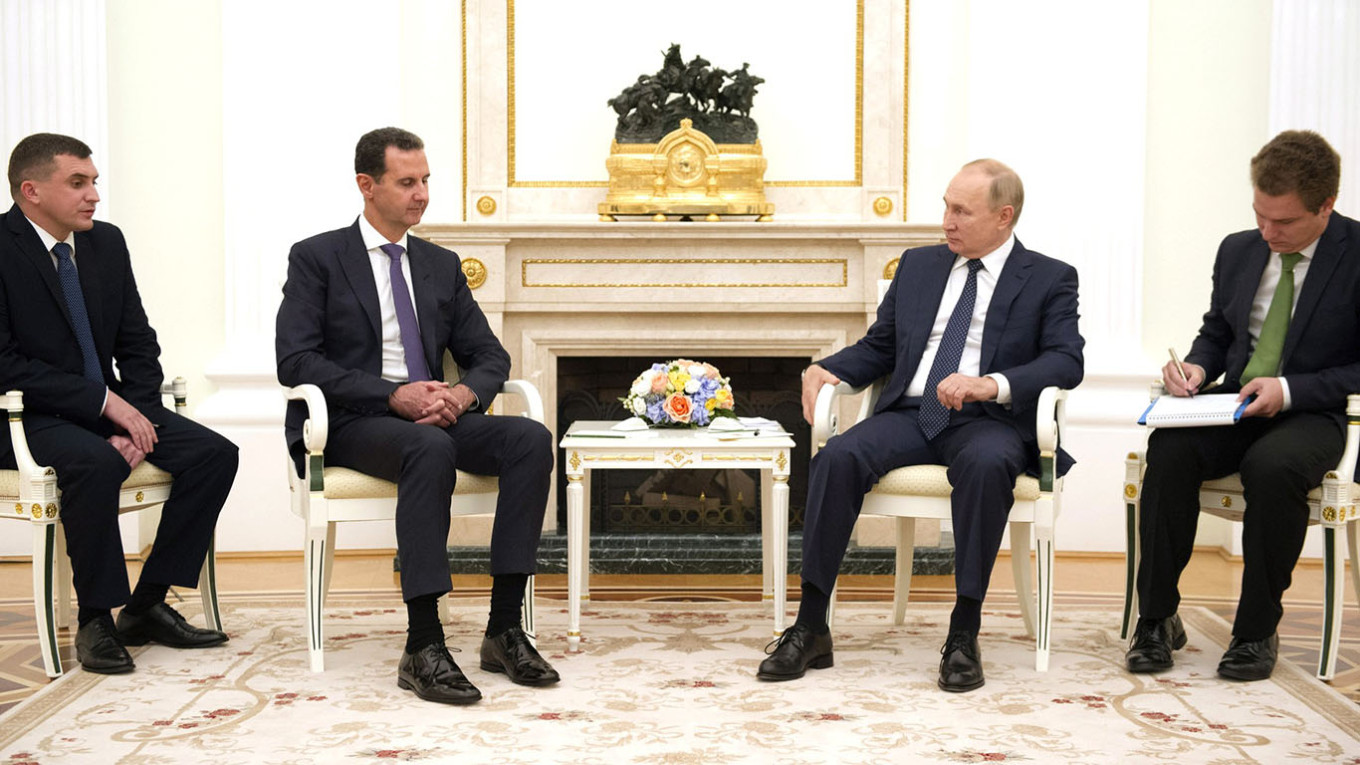 
					Putin (center right) with former Syrian leader Bashar al-Assad (center left) at a meeting in the Kremlin.					 					Kremlin Press Service				