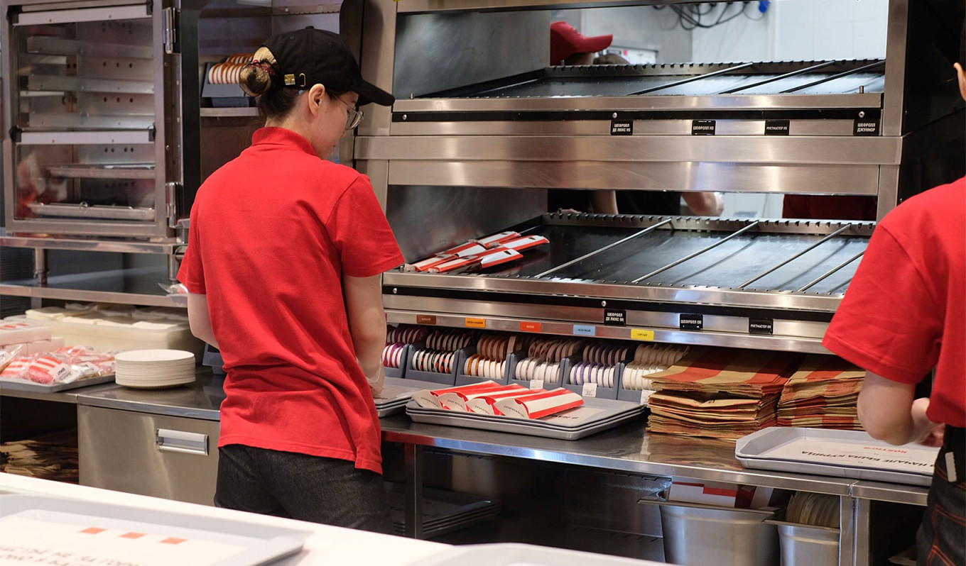 
					An employee preparing food at the rebranded Rostic's, which uses the same equipment as the former KFC restaurant.					 					MT				