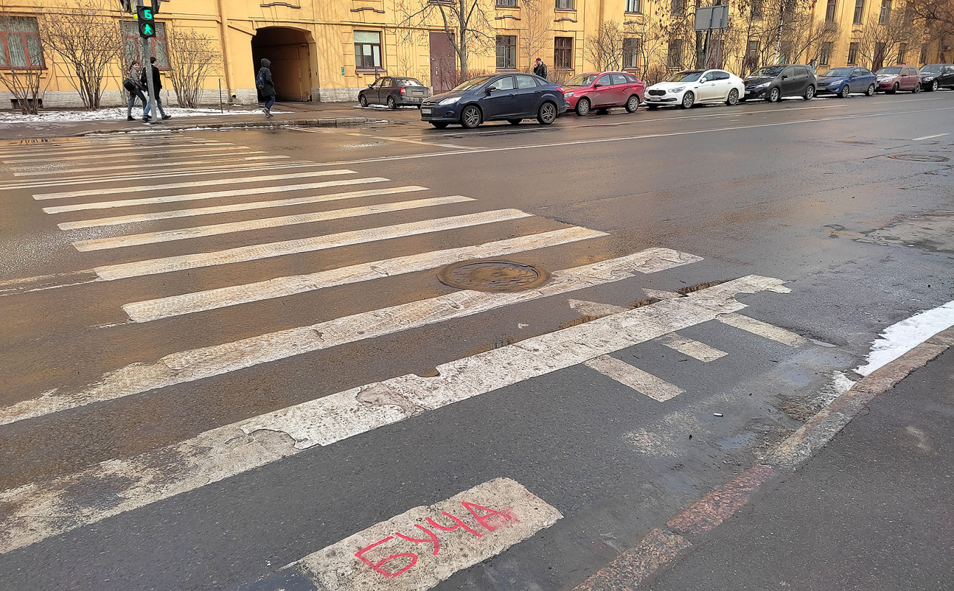 
					The word BUCHA written on a street crosswalk. Vasilevskiy Island, St. Petersburg.					 					MT				