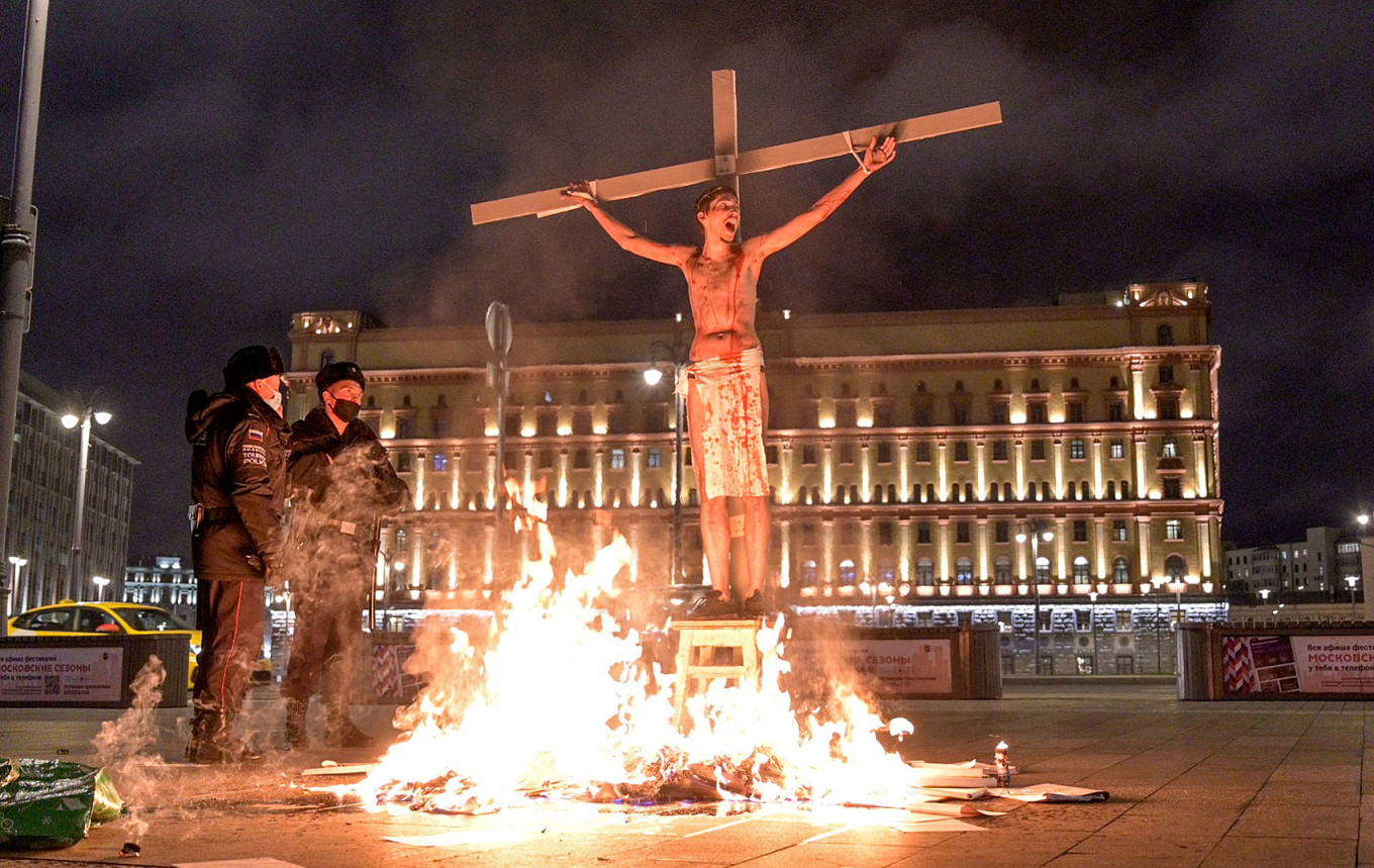 
					Pavel Krisevich attached to a cross in front of the FSB headquarters in central Moscow, late on Nov. 5, 2020, during a performance symbolizing pressure on political activists.					 					Georgy Markov / AFP				