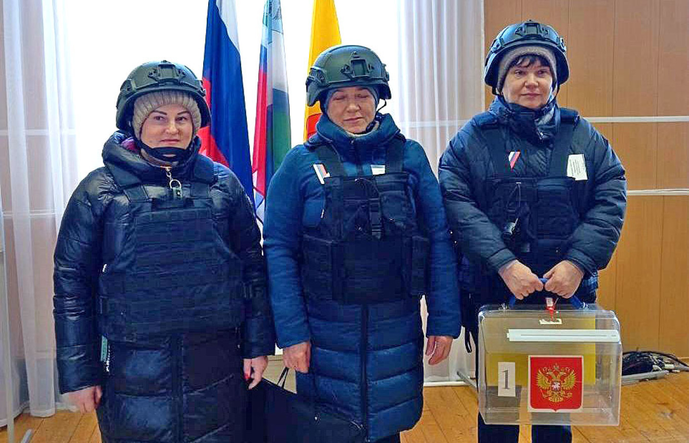 
					Election commission members wearing protective helmets in Belgorod.					 					Election Commission of the Belgorod Region				