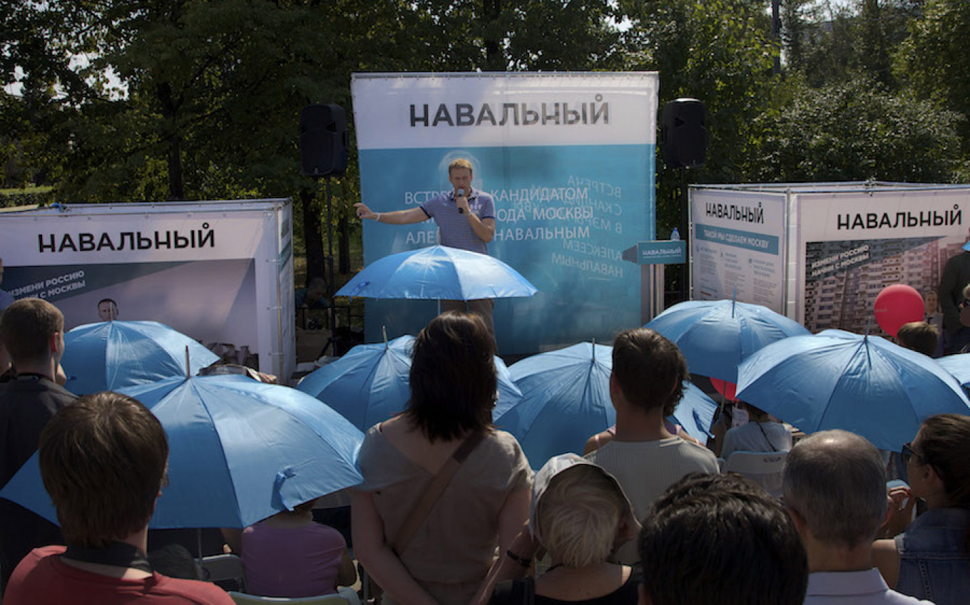 
					In this photo taken Aug. 21, 2013, Moscow residents listen to Alexei Navalny, background center, as he campaigns in downtown Moscow. 					 					Ivan Sekretarev / AP				