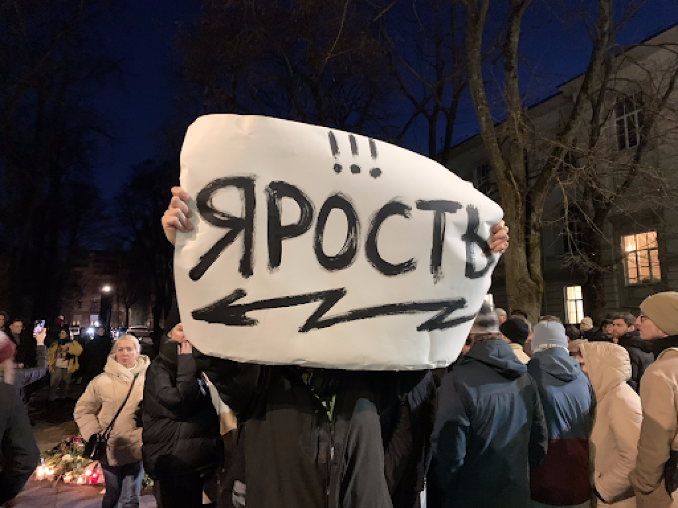 
					A protester holds up a sign reading "Rage."					 					Lukas Žalalis / MT				